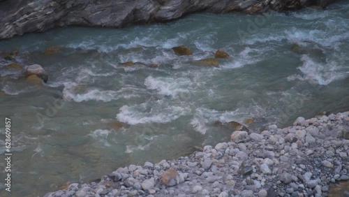 Slow motion shot of Himalayan river during summer season. Beas river in Manali, Himachal Pradesh. Nature landscape. photo