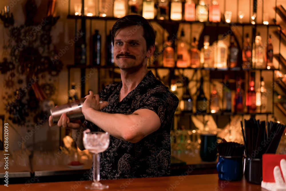 Close-up of a bartender mixing a cocktail with ice behind the bar at a club bar the concept of loving alcoholic beverages and mixing them 