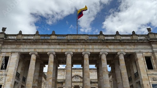 facade of the Senate of the Republic of Colombia with the flag waving in the center of Bogotá