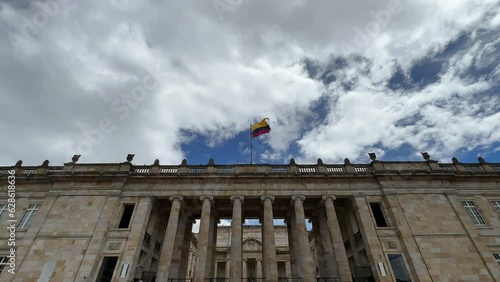facade of the Senate of the Republic of Colombia with the flag waving in the center of Bogotá