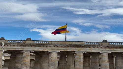 facade of the Senate of the Republic of Colombia with the flag waving in the center of Bogotá