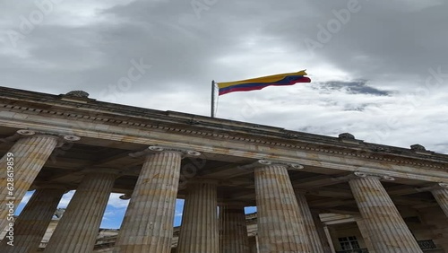 facade of the Senate of the Republic of Colombia with the flag waving in the center of Bogotá