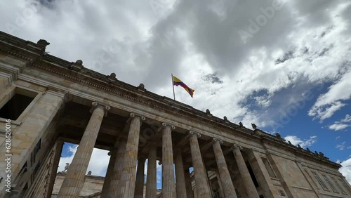 facade of the Senate of the Republic of Colombia with the flag waving in the center of Bogotá