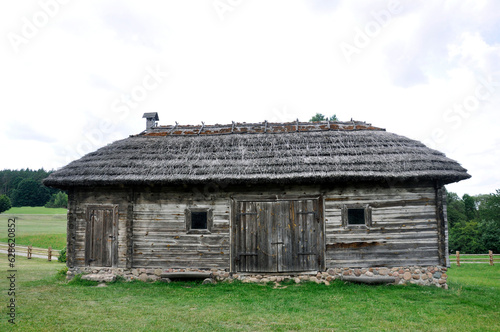 Authentic wooden barn with a thatched roof, Kosovo, Belarus. photo