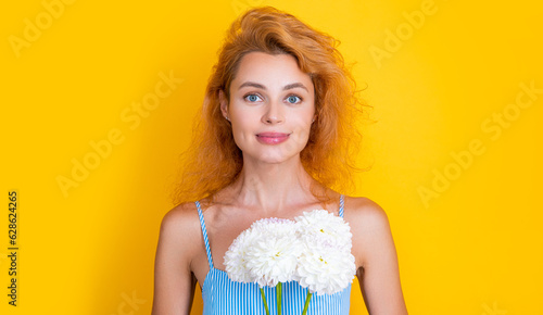 cheerful girl with womens day flowers in studio. girl with womens day flowers on background.
