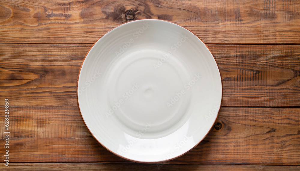 Empty plate on a wooden background. top view. Copyspace. Empty plate on a wooden background. top view. Copyspace.