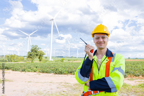 Portrait happy smiling engineer professional techician male working in wind turbines service location site photo