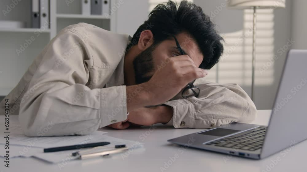 Lazy weary sleepy male manager tired exhausted Arabian Indian businessman employee working computer boring remote job man fall sleep on desktop napping in office overwork fatigue no energy sleeping Lazy weary sleepy male manager tired exhausted Arabian Indian businessman employee working computer boring remote job man fall sleep on desktop napping in office overwork fatigue no energy sleeping