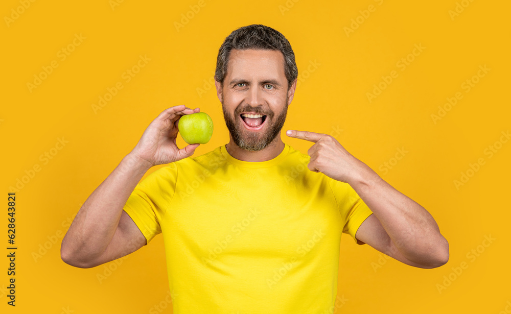 healthy man pointing on vitamin fruit on background. healthy man with vitamin fruit healthy man pointing on vitamin fruit on background. healthy man with vitamin fruit