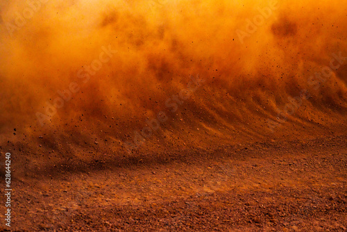 Dust kicked up by a race car on a dirt track 