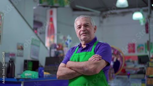 Joyful Supermarket Manager with Arms Crossed, smiling Expression of Older Small Business Owner Inside Store
