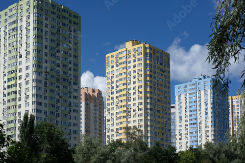 Housing area. High-rise buildings. Residential buildings painted in rainbow colors. Three residential buildings. © Aleksii Smoliakov