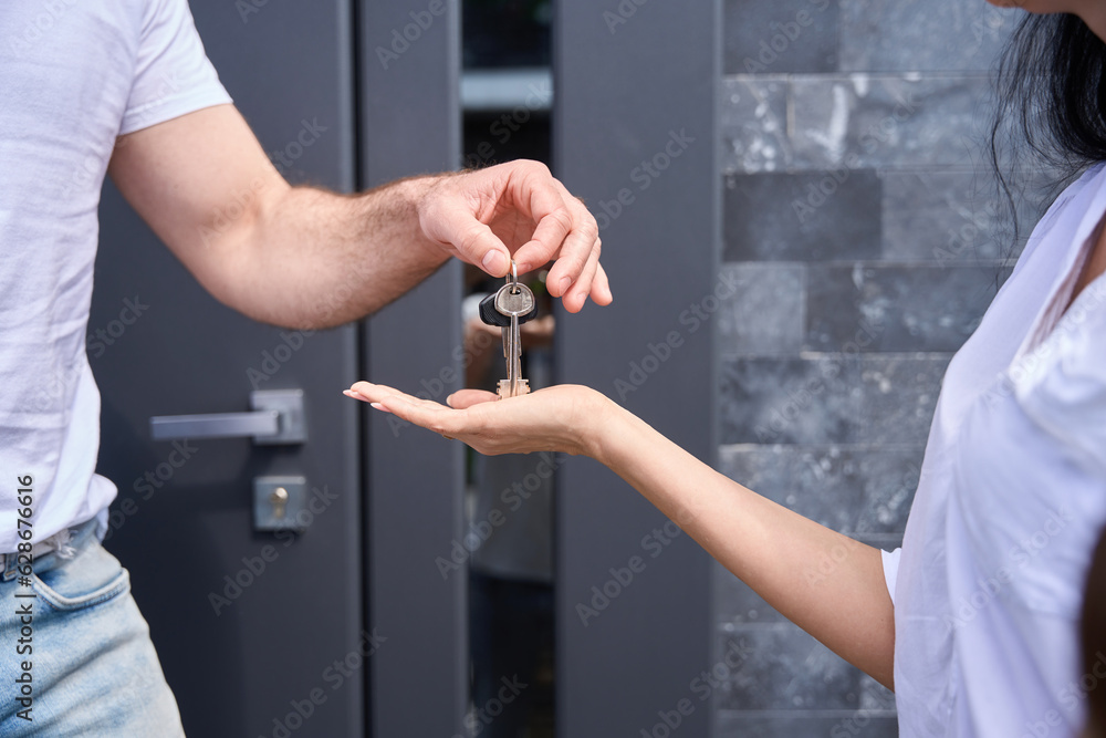 Man gives a woman the keys in his hand