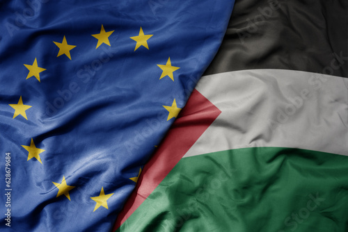 big waving realistic national colorful flag of european union and national flag of palestine .