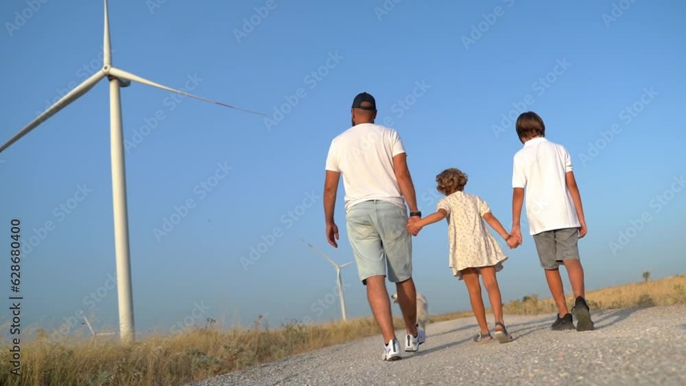 Happy relaxed bearded man raising up arms enjoying travel on nature sunset in the field windmill. Freedom, eco friendly energy, sustainable consumption Happy relaxed bearded man raising up arms enjoying travel on nature sunset in the field windmill. Freedom, eco friendly energy, sustainable consumption