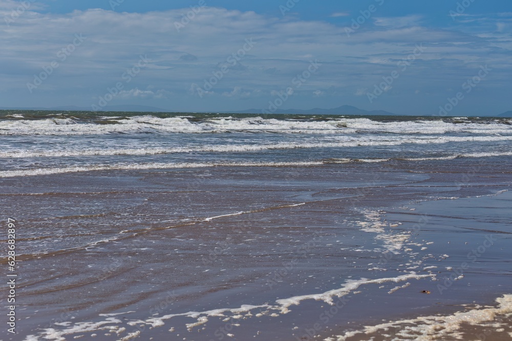 waves on the beach and blue sky