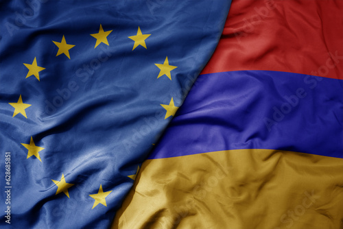 Foto big waving realistic national colorful flag of european union and national flag of armenia