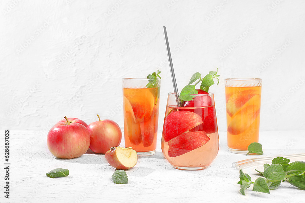 Autumn vitamin mulled wine with apple slices and mint.Apple cider, juice or fruit drink in a glass on a sunny table, Diet and weight loss concept. Apples help cleanse the body and reduce weight. Autumn vitamin mulled wine with apple slices and mint.Apple cider, juice or fruit drink in a glass on a sunny table, Diet and weight loss concept. Apples help cleanse the body and reduce weight.