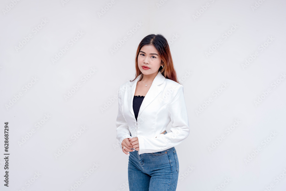 An intense and serious young woman looking blankly straight at the camera. Isolated on a white background. An intense and serious young woman looking blankly straight at the camera. Isolated on a white background.