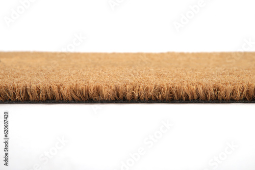 Natural brown coconut fiber doormat. Plain natural dry carpet and dirt outside your entrance, Detail, closeup of fiber and base on white background.