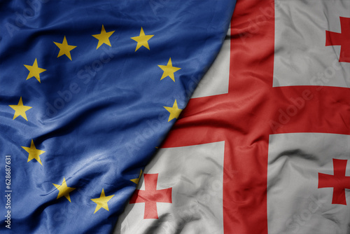 Bild auf Leinwand big waving realistic national colorful flag of european union and national flag of georgia