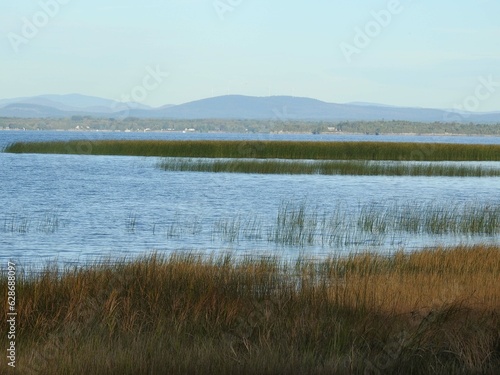 A picturesque view of Lake Champlain from the shores of the Ausable Marsh Wildlife Management Area, with the Adirondack Mountains in the background, Clinton County, Upstate New York.  