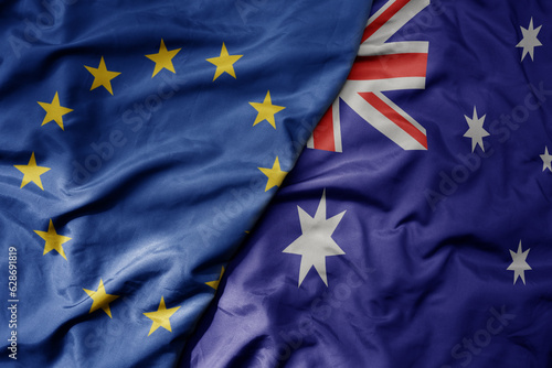 big waving realistic national colorful flag of european union and national flag of australia .