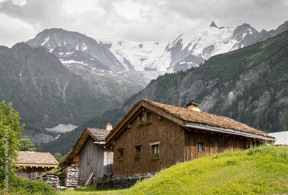 Wooden huts in an Alpine village under the Bionnassay Glacier, on the French side of the Mont Blanc