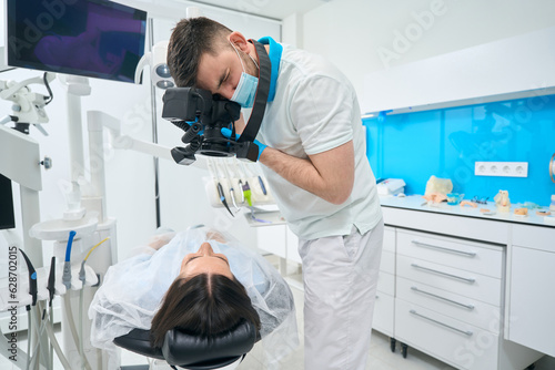 Brunette woman lies in a dental chair