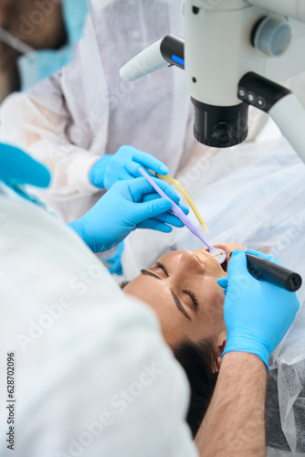 Woman patient lies in a dental chair