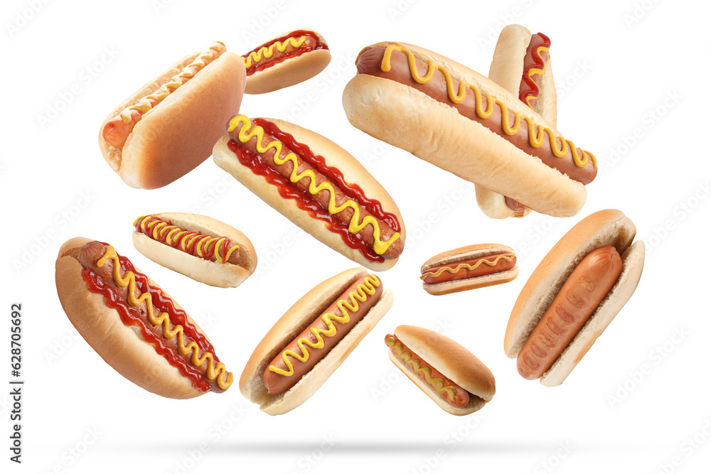 Fototapeta premium Many tasty hot dogs falling on white background