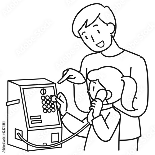 公衆電話の使い方を教える男性とかけるを練習する女の子