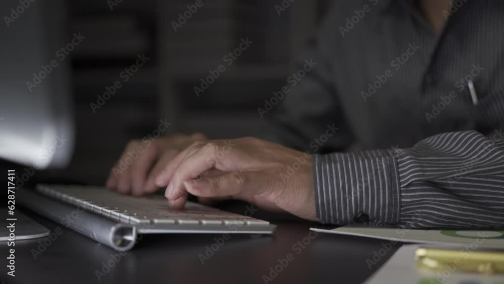Asian male businessman working with financial documents and desktop computer till late at office, young man working overtime salaryman concept 4k Asian male businessman working with financial documents and desktop computer till late at office, young man working overtime salaryman concept 4k