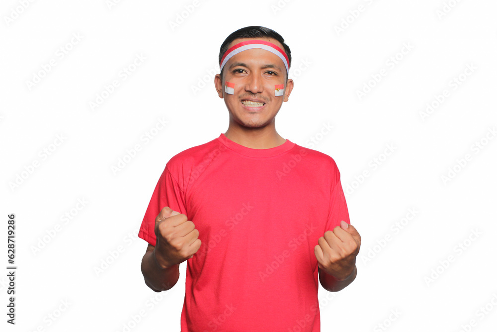 Asian young man wearing red t-shirt giving a salute gesture isolated on white background. Celebrate Indonesia independence day on 17 August. Asian young man wearing red t-shirt giving a salute gesture isolated on white background. Celebrate Indonesia independence day on 17 August.