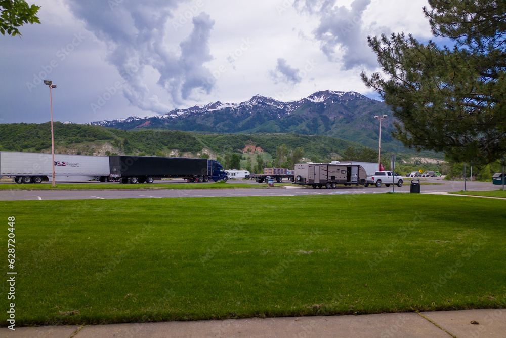 trucks is parked in front of a mountain range.