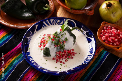 Chile en Nogada, Typical dish from Mexico. Prepared with poblano chili stuffed with meat and fruits and covered with a walnut sauce. Named as the quintessential Mexican dish for national holidays.