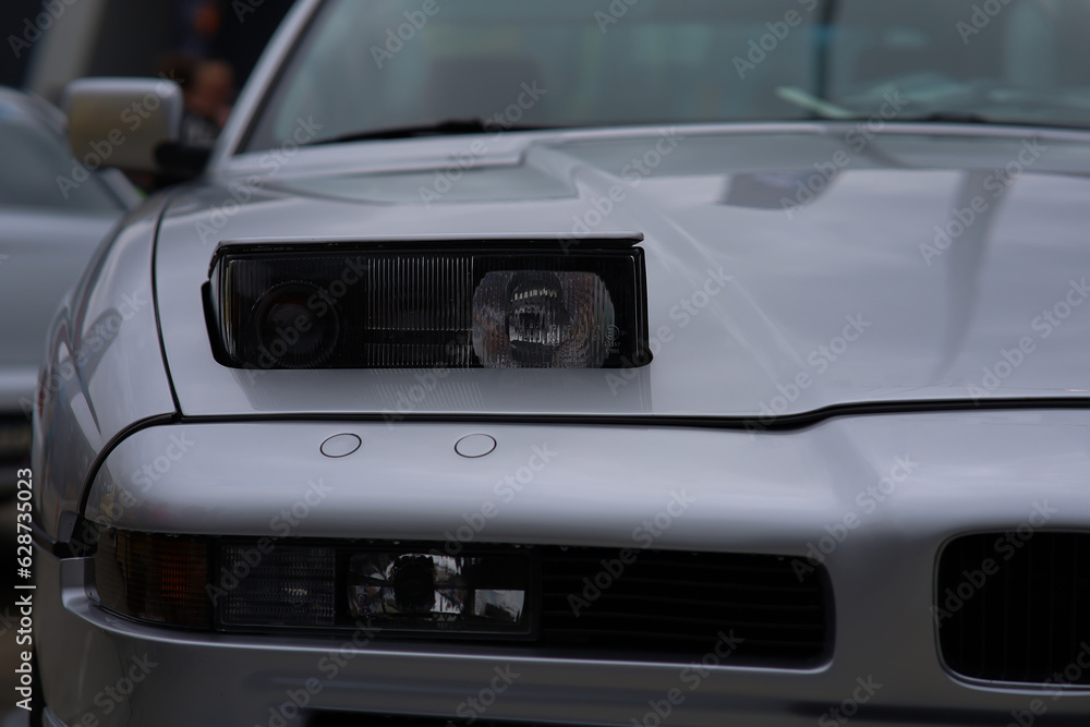 retractable headlight close-up on a gray sports car
