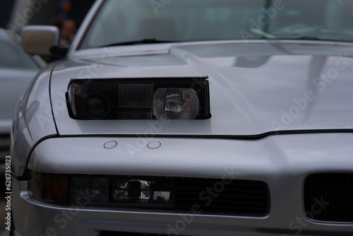 retractable headlight close-up on a gray sports car 