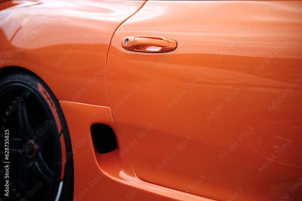 Orange tuned sports luxury car fragment. Sport car at the start.