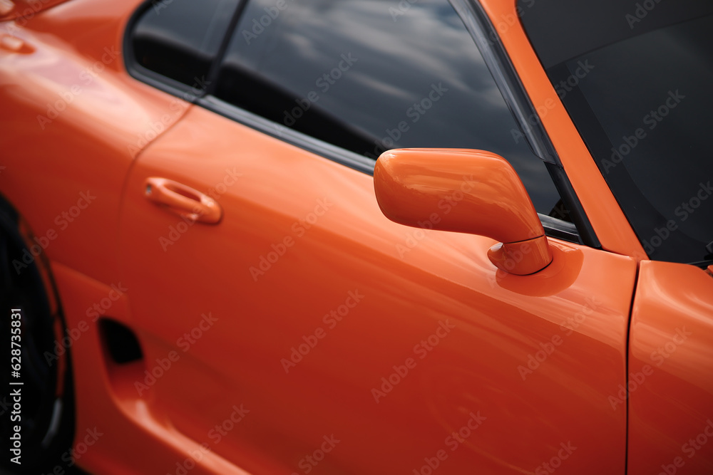 Orange tuned sports luxury car fragment. Sport car at the start.