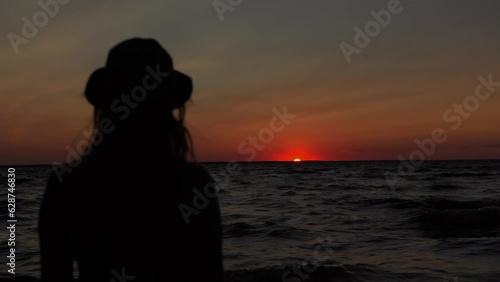 Domestic violence against women woman standing on a seashore watching at sunset thinking about family problems