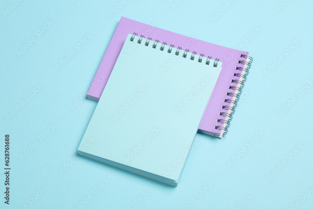 Two notebooks on blue pastel background. Minimalism. Creative layout Two notebooks on blue pastel background. Minimalism. Creative layout