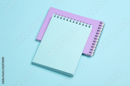 Two notebooks on blue pastel background. Minimalism. Creative layout