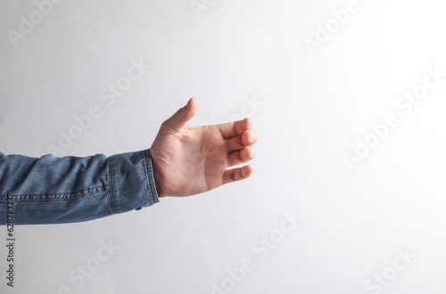 Mockup of a male hand in a denim shirt to hold on a gray background