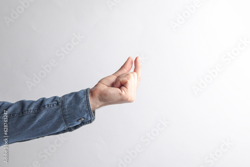 Mockup of a male hand holding a business card on a gray background