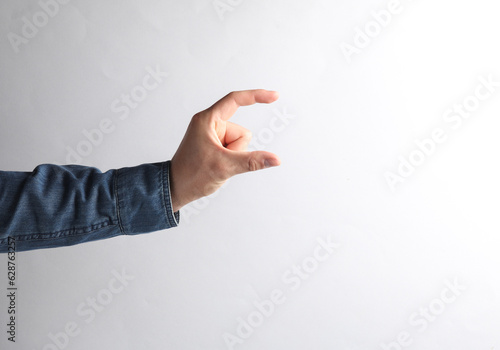 Mockup of a male hand holding a business card on a gray background