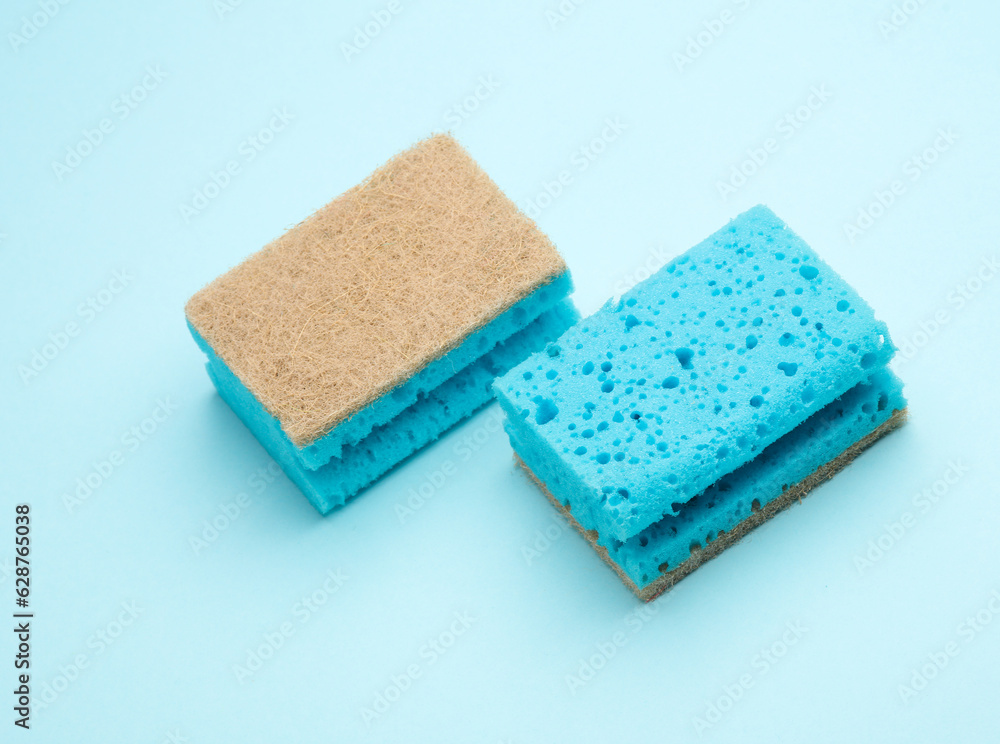 Two cleaning sponges on blue background Two cleaning sponges on blue background