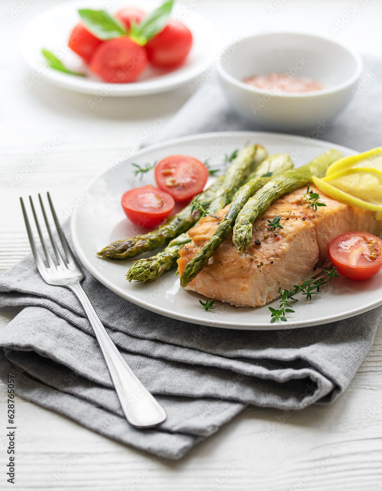 Baked Delicious salmon, green asparagus on plate Baked Delicious salmon, green asparagus on plate