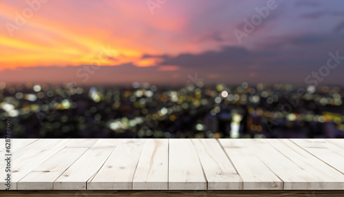 Wood table front view with blank city sunset background for product display
