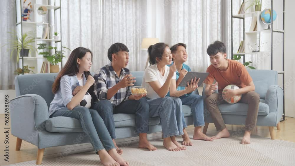 Asian Teenagers Cheering And Watching Football Game On Tablet And Disappointed At Home
Asian Teenagers Cheering And Watching Football Game On Tablet And Disappointed At Home
